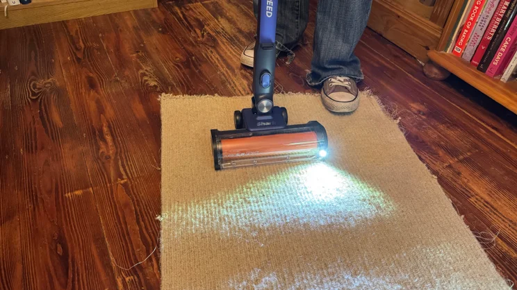 A picture showing the Shark PowerDetect Speed Clean and Empty Pet Pro's reveal led light in action