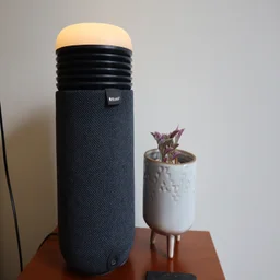 The Blueair Mini Restful air purifier on a bedside table, alongside a small potted plant