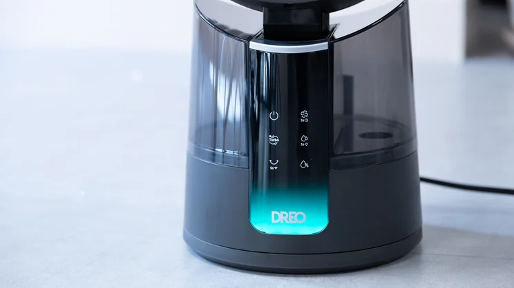 A closeup of the Dreo TurboCool Misting Fan 516S's base and control panel. The display is on