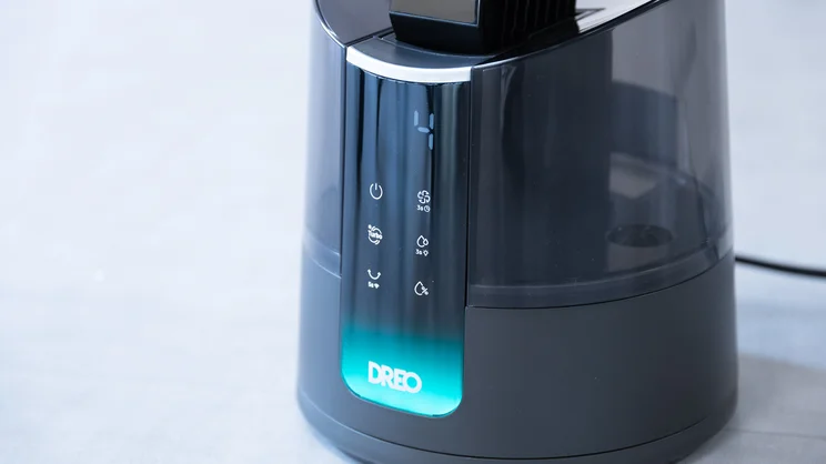 A closeup of the Dreo TurboCool Misting Fan 516S's base and control panel. The display is on