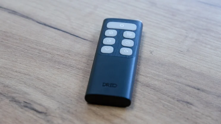 The Dreo TurboCool Misting Fan 516S's remote control on an office table