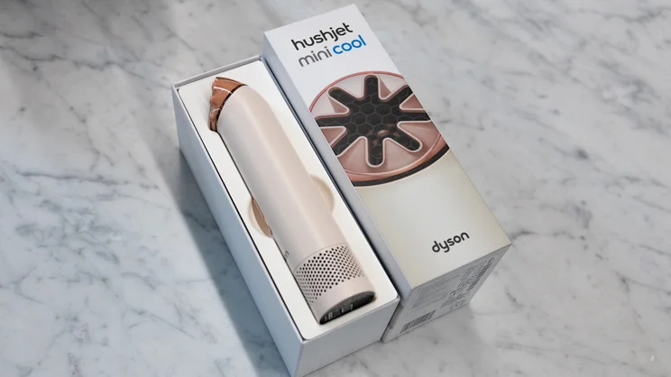 The Dyson HushJet Mini Cool fan in its box, on an office coffee table