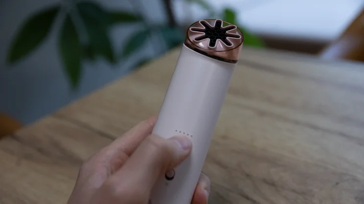A hand operating the Dyson HushJet Mini Cool fan