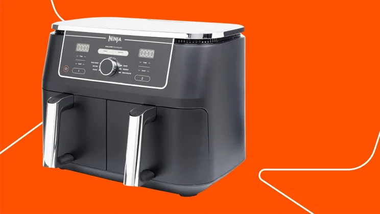 The Ninja Foodi Max Dual Drawer air fryer on an orange background