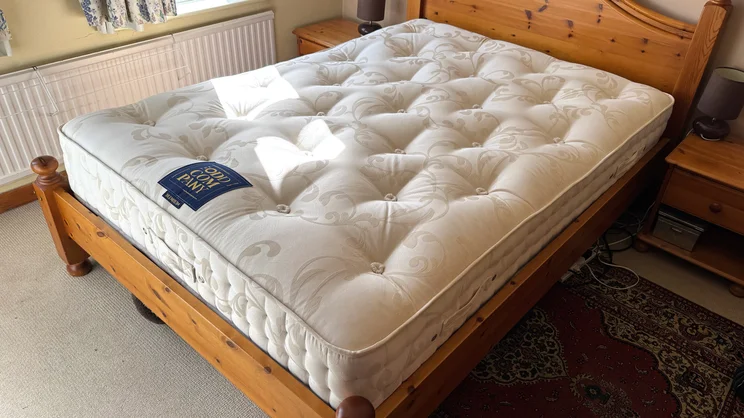 The Odd Company Blenheim 1500 mattress on a wooden bed frame in a well-lit bedroom