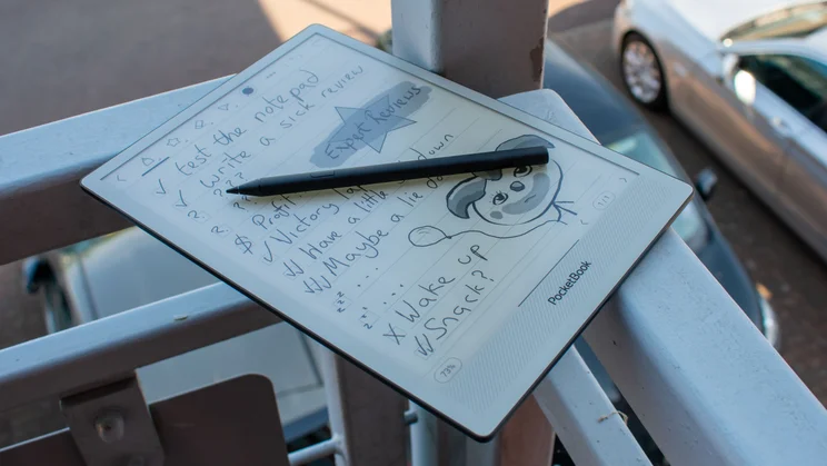 PocketBook InkPad One on a balcony, with stylus on the display