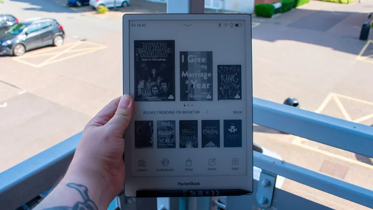 PocketBook InkPad One on a balcony, home page showing recent books