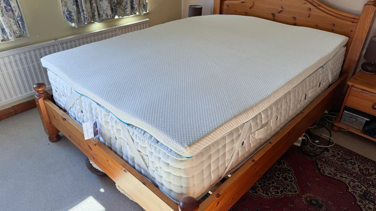 The Simba Cool Foam mattress topper on a mattress in a bedroom