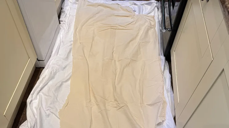 The Simba TripleShield Tencel Cool mattress protector sandwiched between two pieces of polycotton sheets