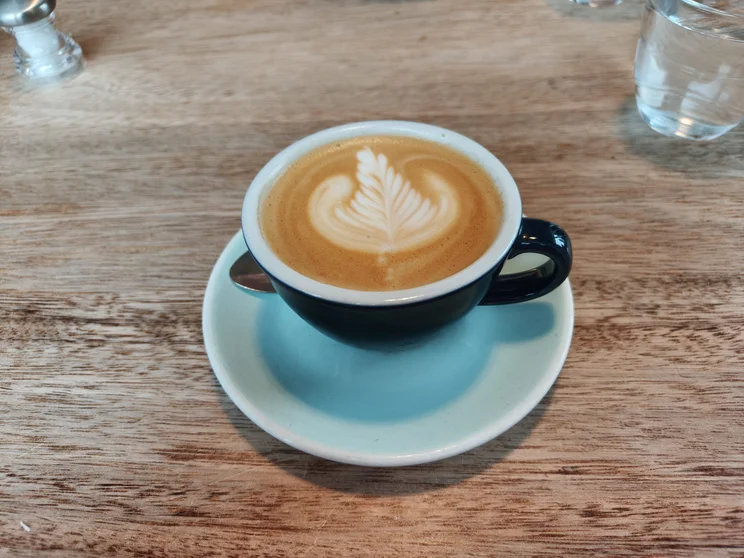 A coffee with a logo in the foam