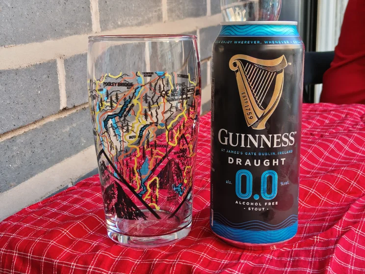 A can of Guinness next to a pint glass