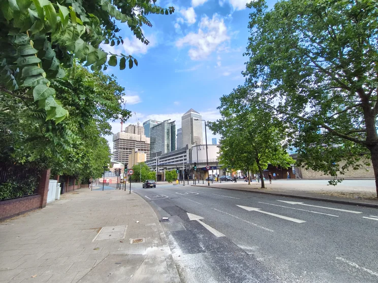 Wide-angle shot of a road with trees on both sides