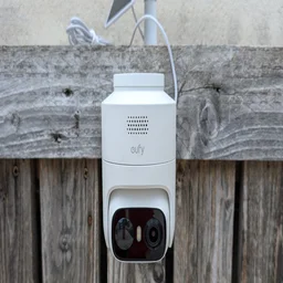 The EufyCam C37 pictured from in front, mounted on a wooden slatted wall
