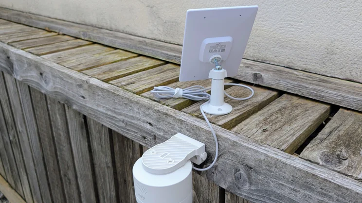 The EufyCam C37 pictured mounted on a wooden fence