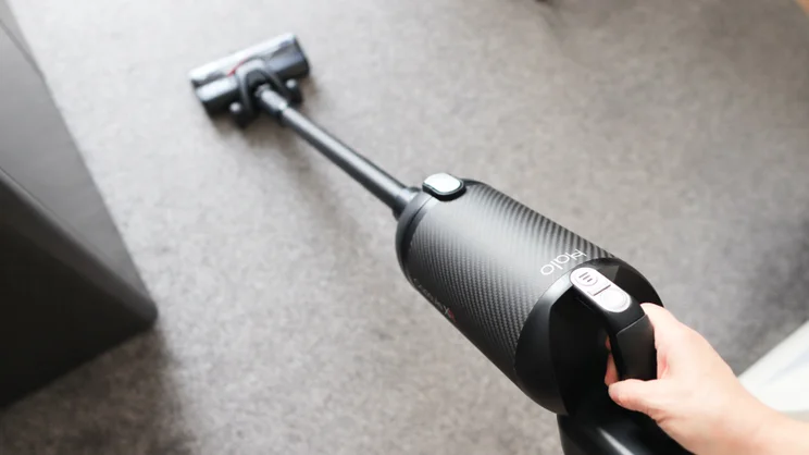 The Halo Capsule XR in operation being used to vacuum a grey carpet