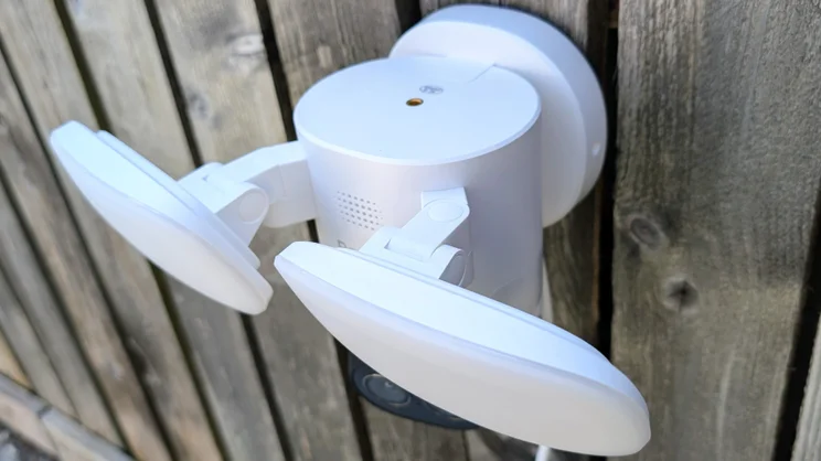 The Reolink TrackFlex mounted on a wooden fence, pictured from above