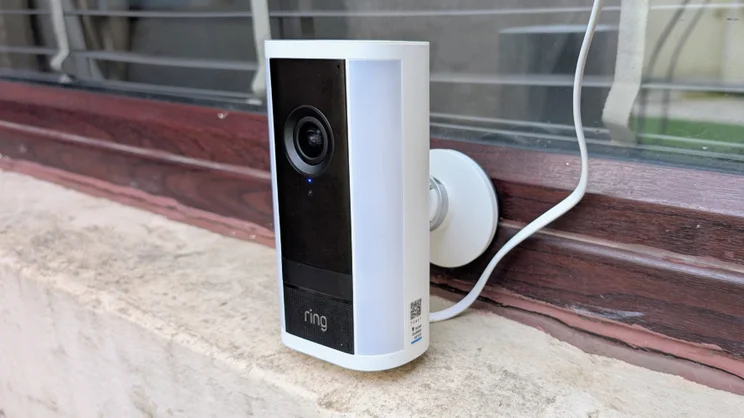 The Ring Spotlight Cam Pro Plug-In (2nd gen) pictured on a window sill from its right side