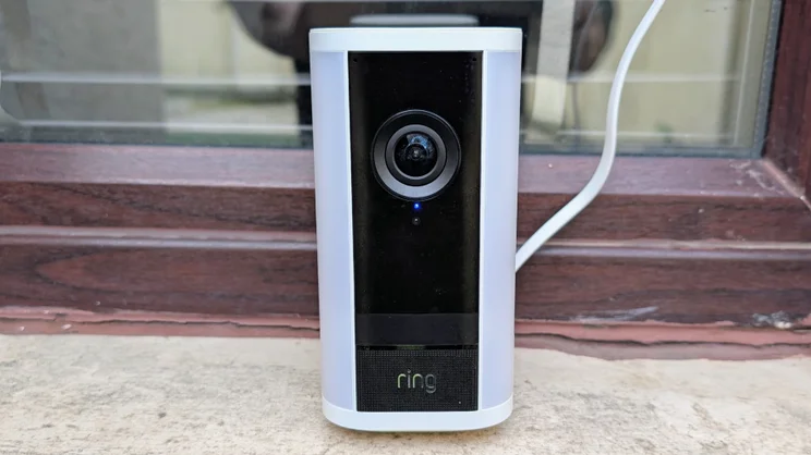 The Ring Spotlight Cam Pro Plug-In (2nd gen) pictured on a window sill, from the front