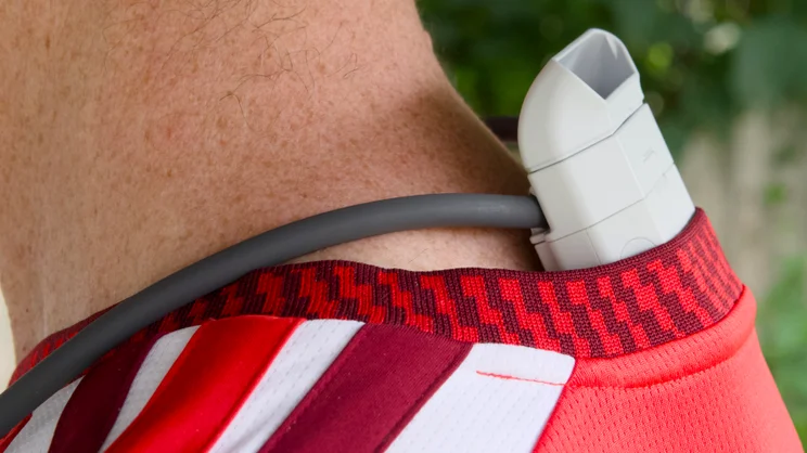 The Sony Reon Pocket Pro Plus pictured from the left side, being worn under a loose fitting football shirt