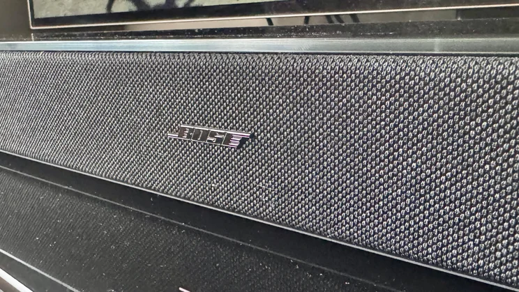 Close up of the Bose logo on the front of the Bose Lifestyle Ultra Soundbar