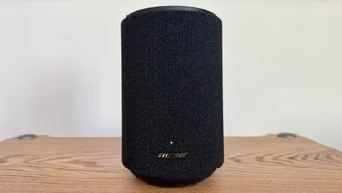 Front view of the Bose Lifestyle Ultra Speaker on a wooden table