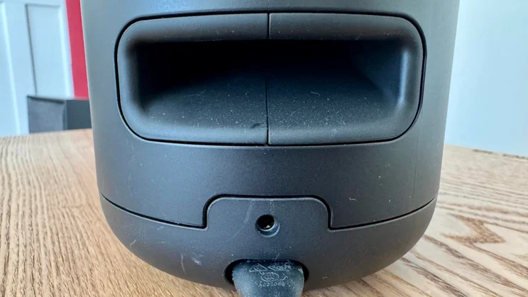 Rear view of the Bose Lifestyle Ultra Speaker showing the QuietPort bass reflex port and power cable plugged in