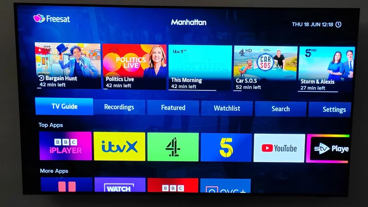 A 65in Philips TV displaying the Freesat homepage