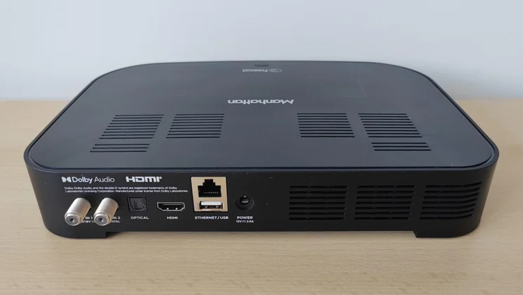 Rear view of the Manhattan S4-R Freesat TV Recorder on a wooden table showing the connection ports