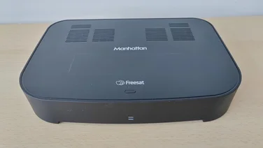 The Manhattan S4-R Freesat TV Recorder on a wooden table