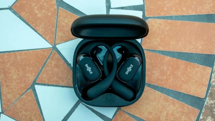The Shokz OpenFit 2+ on a table in a garden