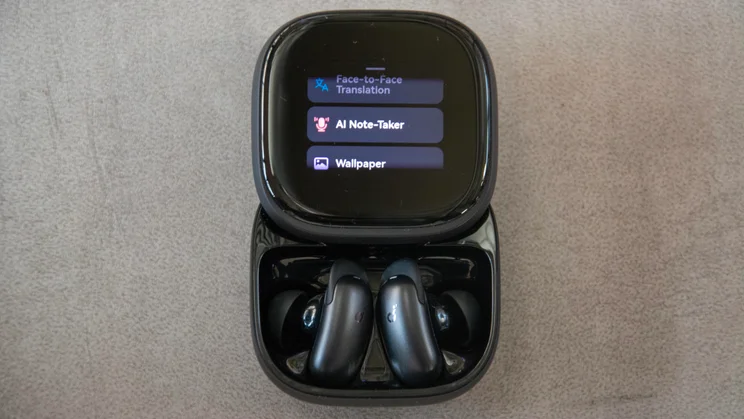 The Soundcore Liberty 5 Pro Max wireless earbuds in their charging case with the lid open and the AI Note-Taker feature on screen