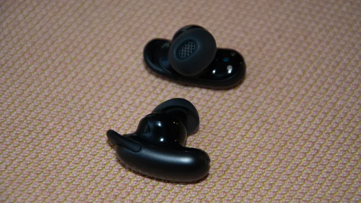 The Soundcore Liberty 5 Pro Max wireless earbuds side by side on a sofa
