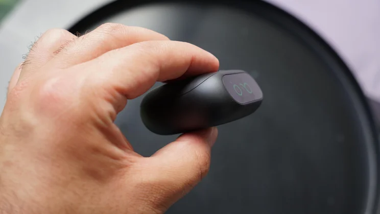 The Soundcore Liberty 5 Pro true wireless earbuds charging case being held in the hand of reviewer Simon Cocks