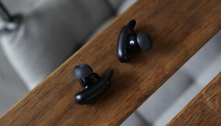 The Soundcore Liberty 5 Pro true wireless earbuds on a wooden slat