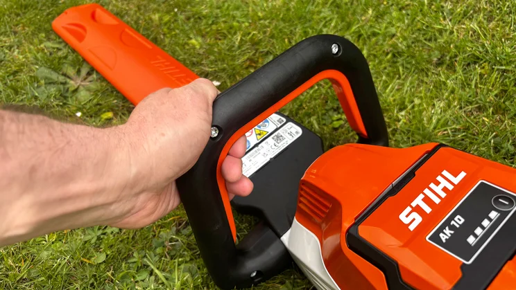 Stihl HSA 50 hedge trimmer - close-up of handle gripped by man's hand