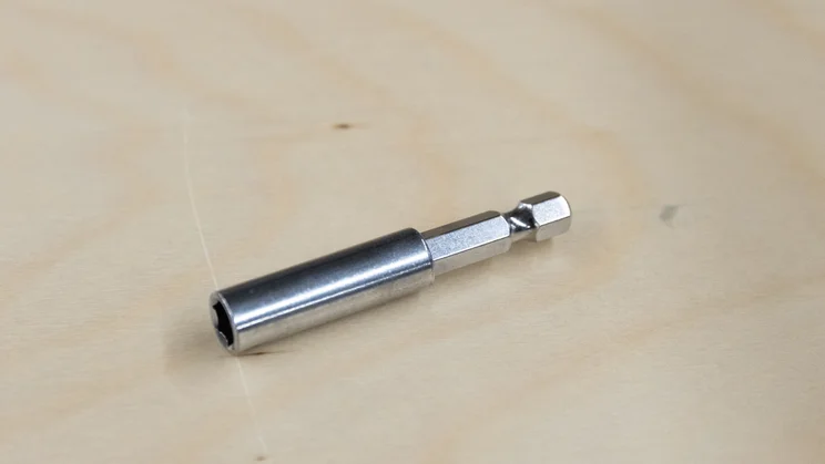The AeroPress Manual Coffee Grinder's drill adapter on a table