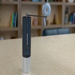The AeroPress Manual Coffee Grinder on a table in an office