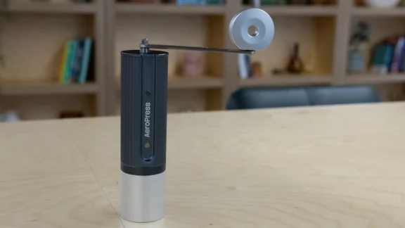 The AeroPress Manual Coffee Grinder on a table in an office