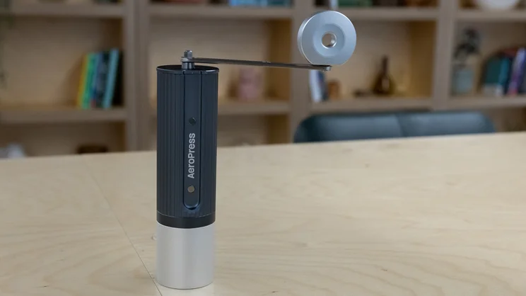 The AeroPress Manual Coffee Grinder on a table in an office