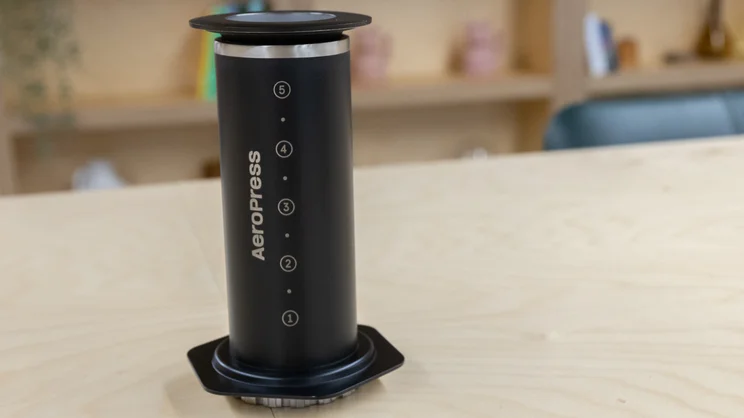 The AeroPress Steel coffee maker on a table in an office