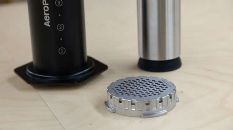 A closeup of the AeroPress Steel coffee maker's components