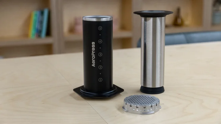 The components of the AeroPress Steel coffee maker, on a table in an office