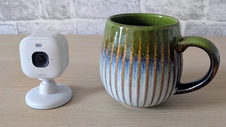 Blink Mini 2K Plus - camera next to mug for scale