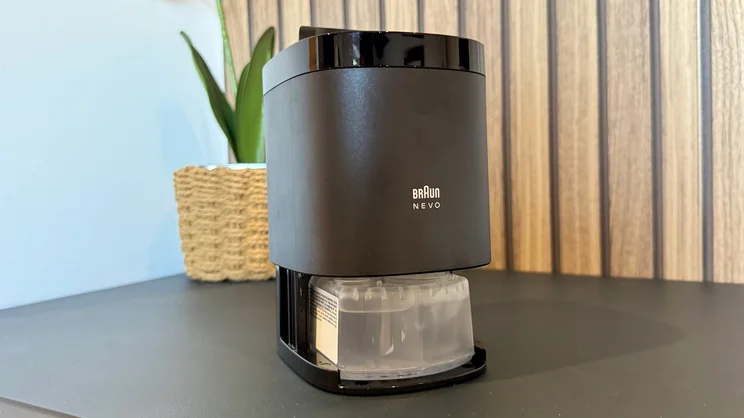 The Braun Nevo electric shaver's cleaning station, opened to reveal cleaning cartridge compartment