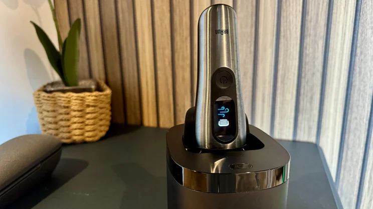 The Braun Nevo electric shaver in its cleaning station on a table