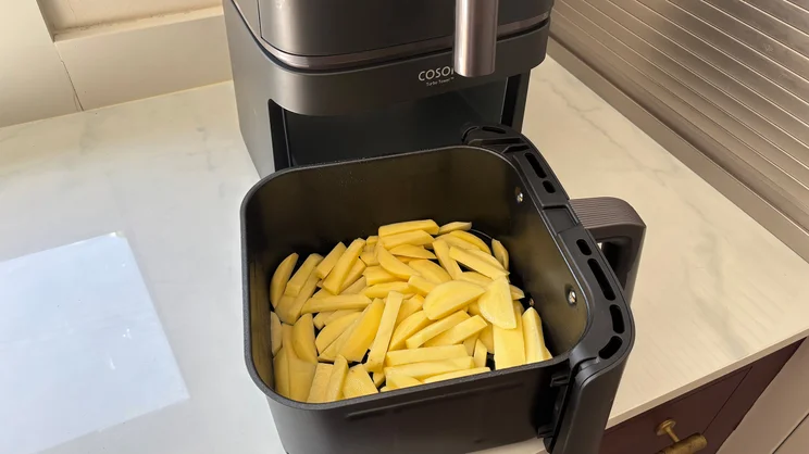 Raw chips in the larger drawer of the Cosori Turbo Tower air fryer