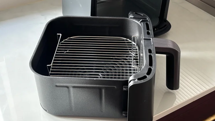 The larger drawer of the Cosori Turbo Tower air fryer, with roasting plate inserted