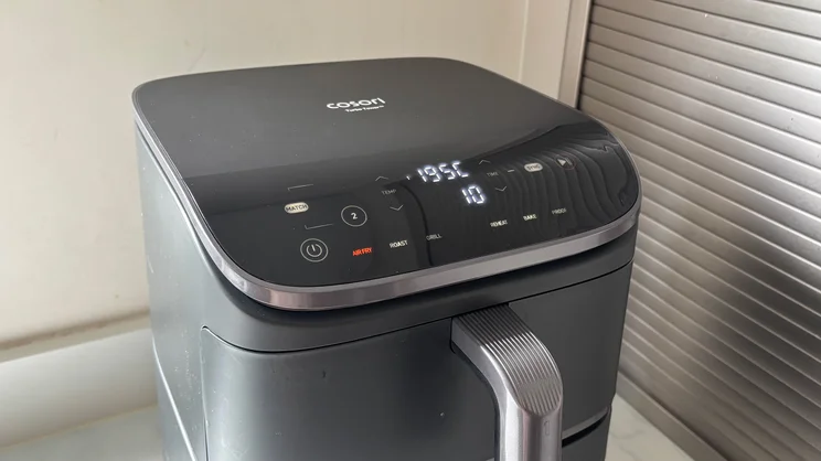 The Cosori Turbo Tower air fryer with its digital display on
