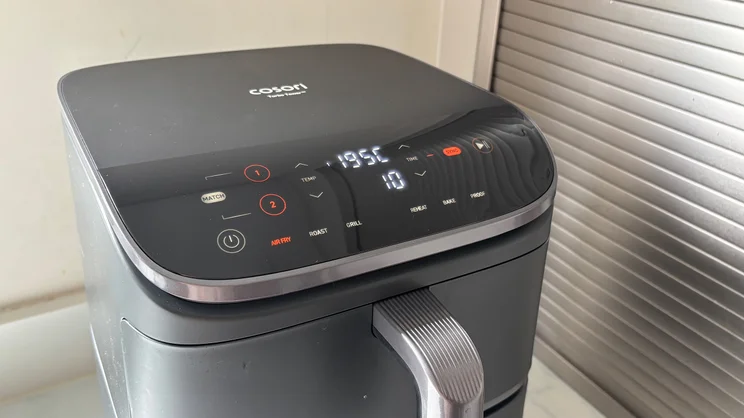 The Cosori Turbo Tower air fryer with its digital display on
