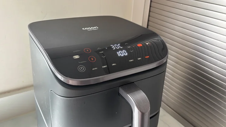 The Cosori Turbo Tower air fryer with its digital display on